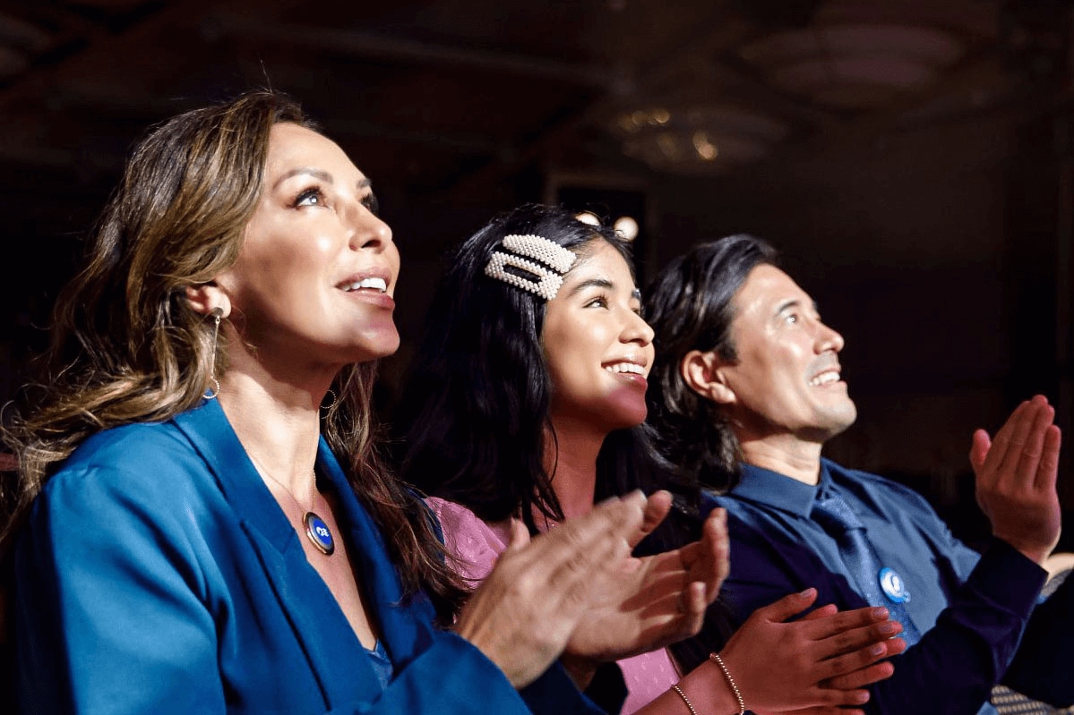 Three women watching a theatre play